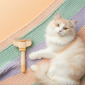 FurVeylo Pet Grooming Comb flat lay with fluffy cat on pastel blanket